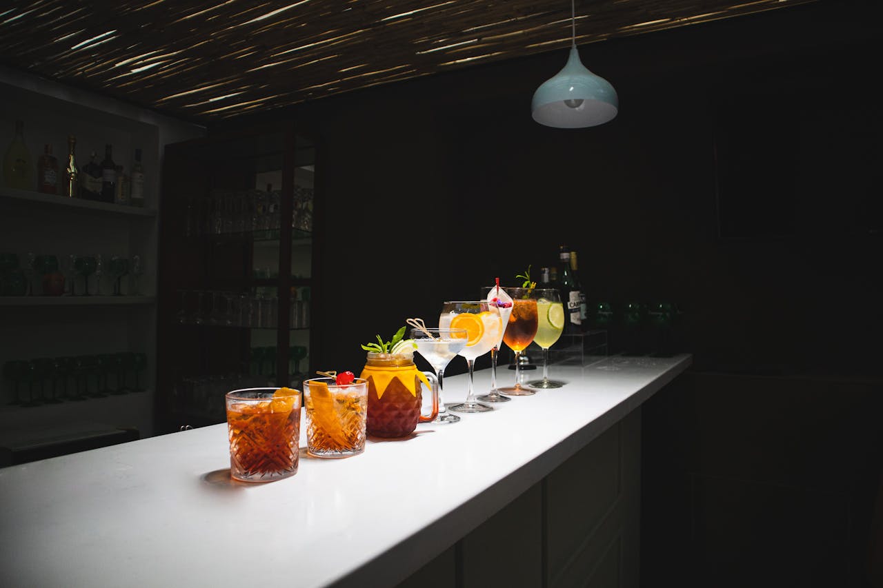 A stylish lineup of cocktails on a modern bar counter in Cuenca, Ecuador.